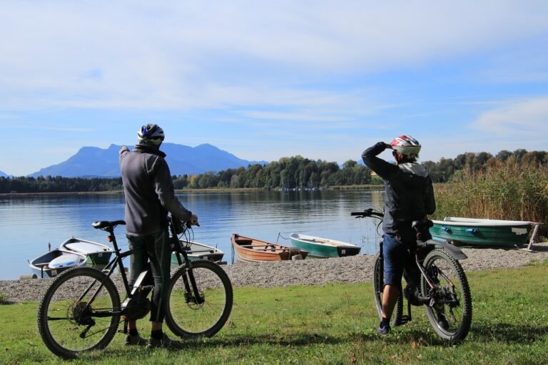 Casal andando de bicicleta em frente ao lago